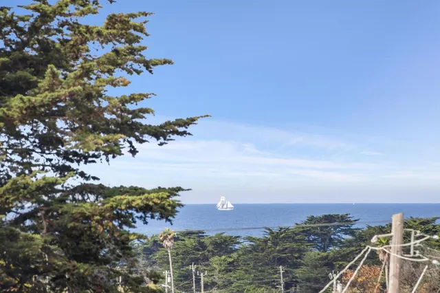 a view of a deck with table and chairs with wooden floor and fence