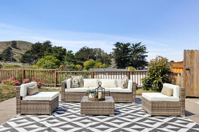 a view of a house with swimming pool and sitting area