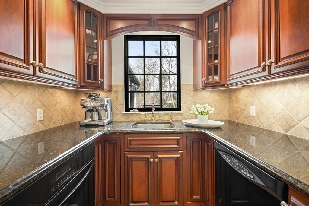 77 Woodcliff Road Wellesley, MA 02481 - Photo 18 of 42 a kitchen with granite countertop a sink and a window