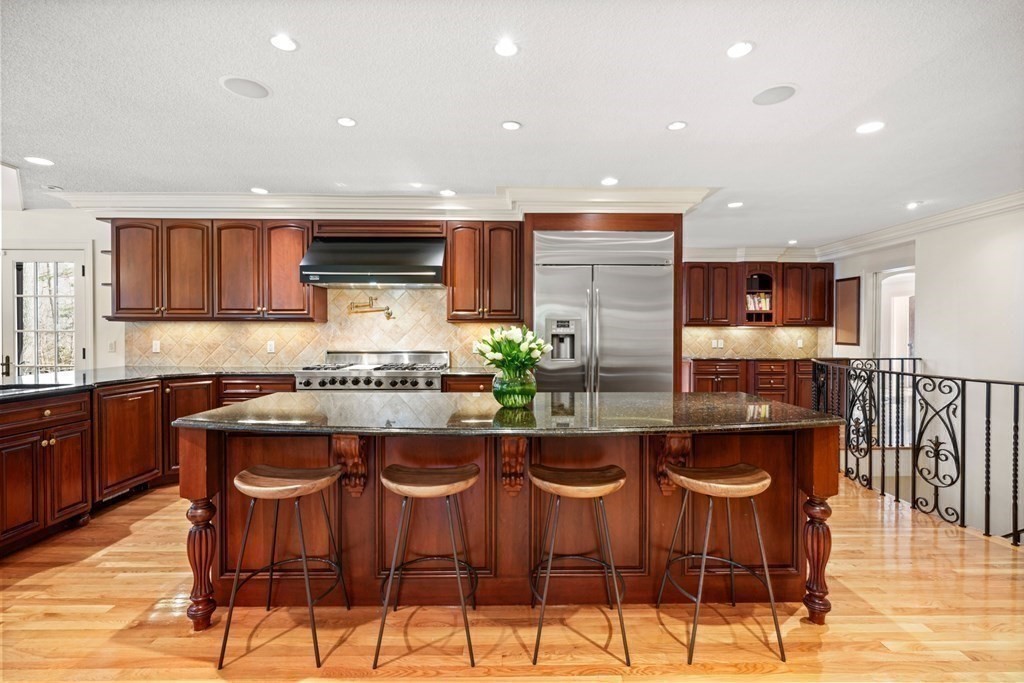 77 Woodcliff Road Wellesley, MA 02481 - Photo 20 of 42 a kitchen with stainless steel appliances kitchen island granite countertop a stove a sink and a refrigerator