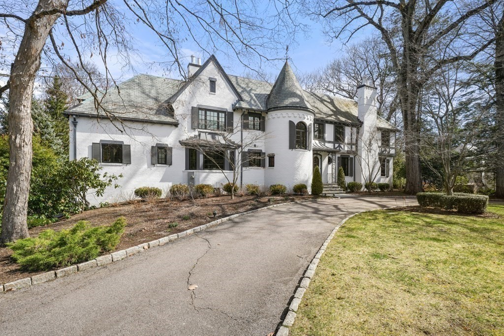 77 Woodcliff Road Wellesley, MA 02481 - Photo 2 of 42 a view of a white house with a large windows next to a road