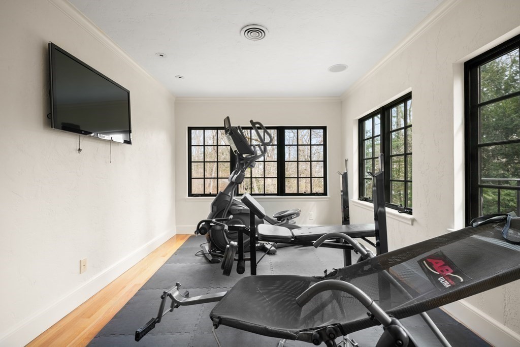 77 Woodcliff Road Wellesley, MA 02481 - Photo 29 of 42 a view of a livingroom with furniture and a flat screen tv
