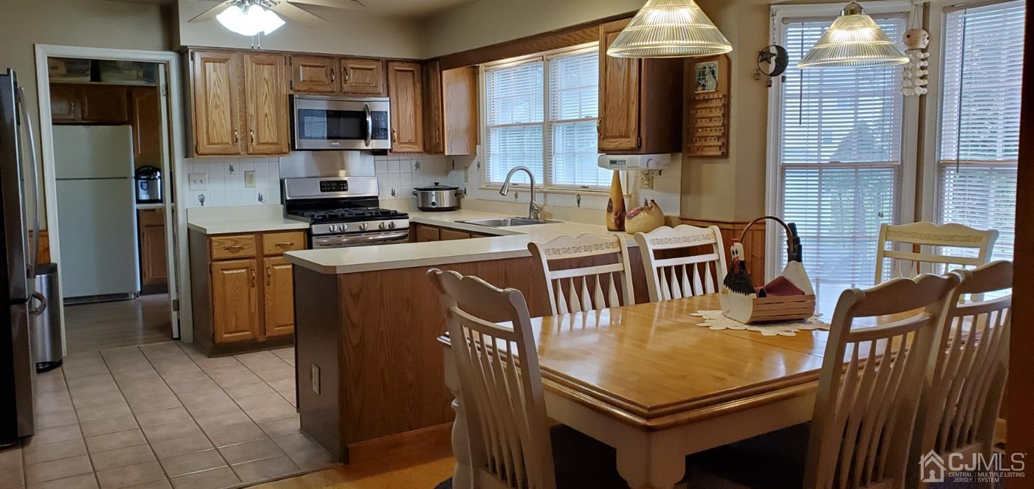 3 Interlaken Road Monmouth Junction, NJ 08852 - Photo 11 of 21 a kitchen with stainless steel appliances a stove a sink a microwave a refrigerator and cabinets