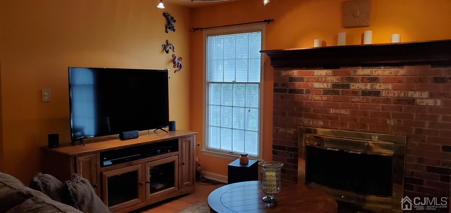 3 Interlaken Road Monmouth Junction, NJ 08852 - Photo 15 of 21 a living room with a fireplace and a flat screen tv