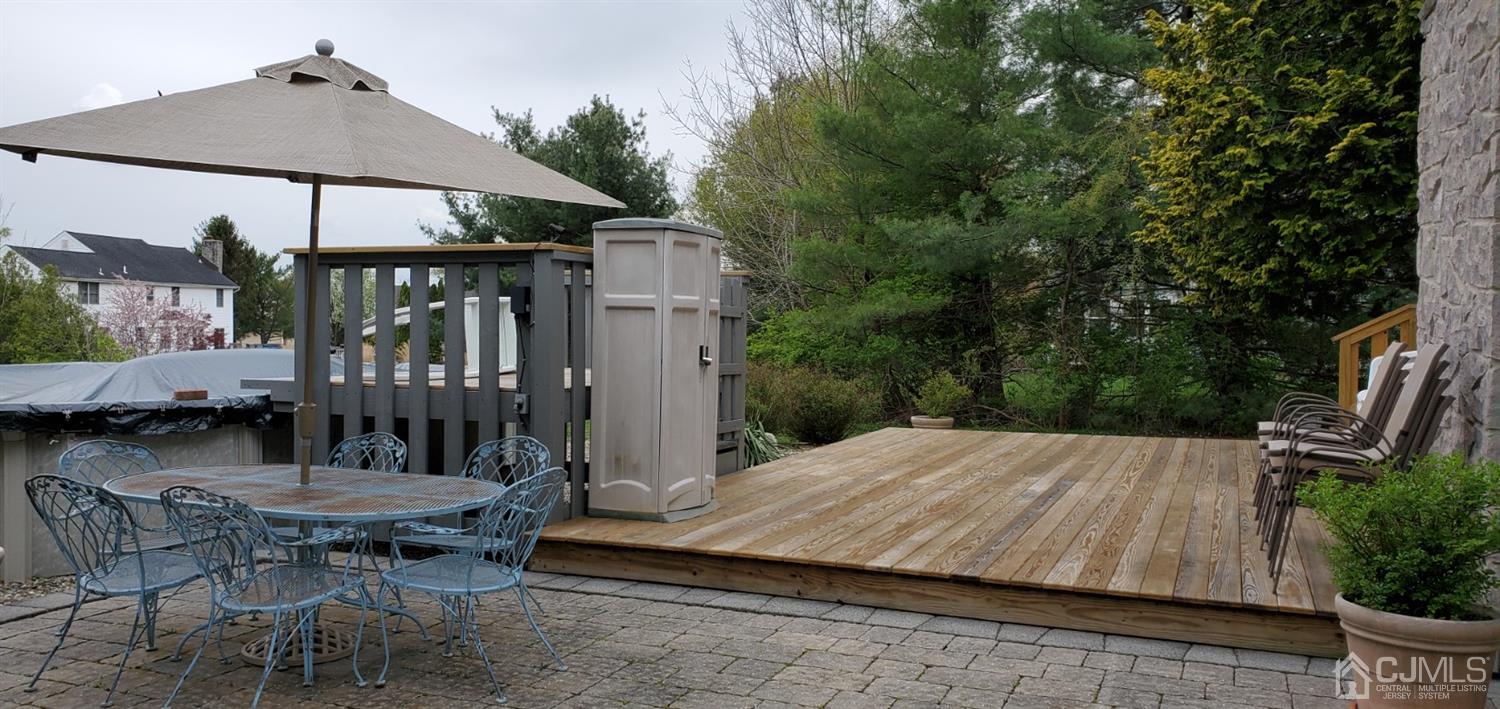 3 Interlaken Road Monmouth Junction, NJ 08852 - Photo 10 of 21 a view of a patio with a table and chairs under an umbrella