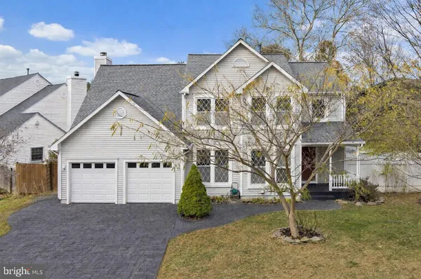 a view of a big house with a yard and garage