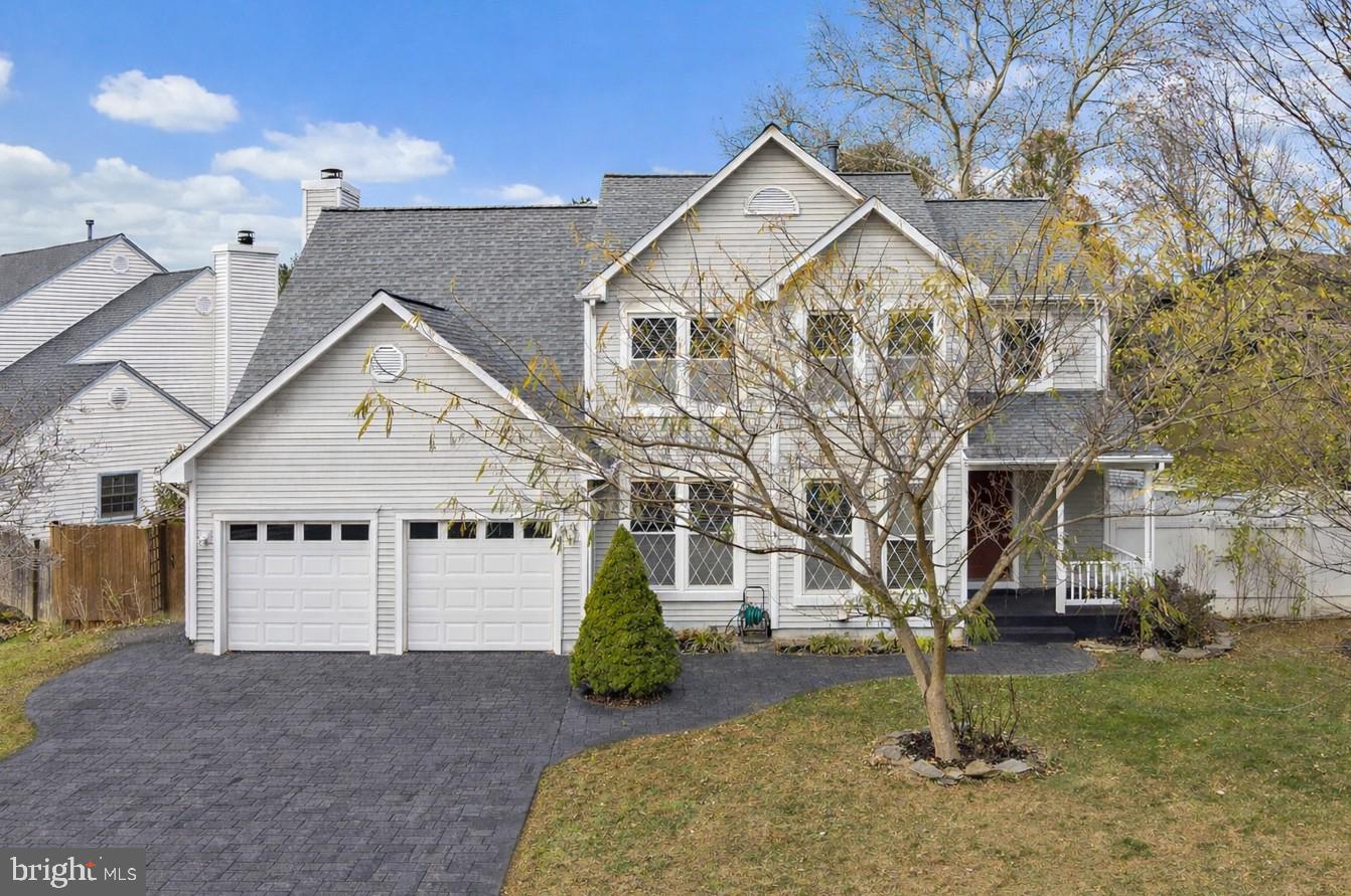 a view of a big house with a yard and garage
