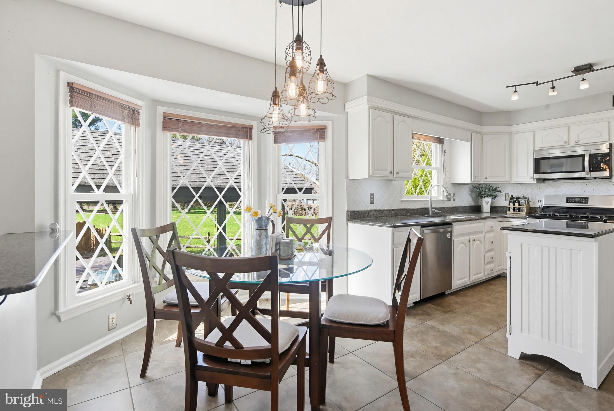 18906 Lindenhouse Road Gaithersburg, MD 20879 - Photo 14 of 48 a dining room filled chandelier and kitchen view