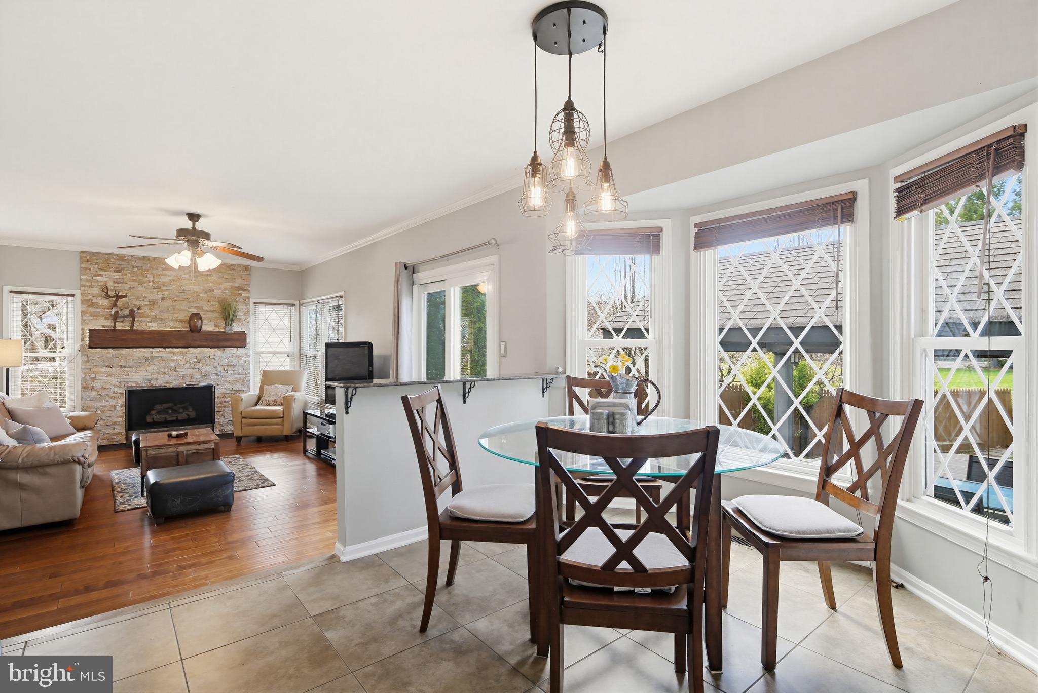 18906 Lindenhouse Road Gaithersburg, MD 20879 - Photo 15 of 48 a dining room with furniture a chandelier and wooden floor