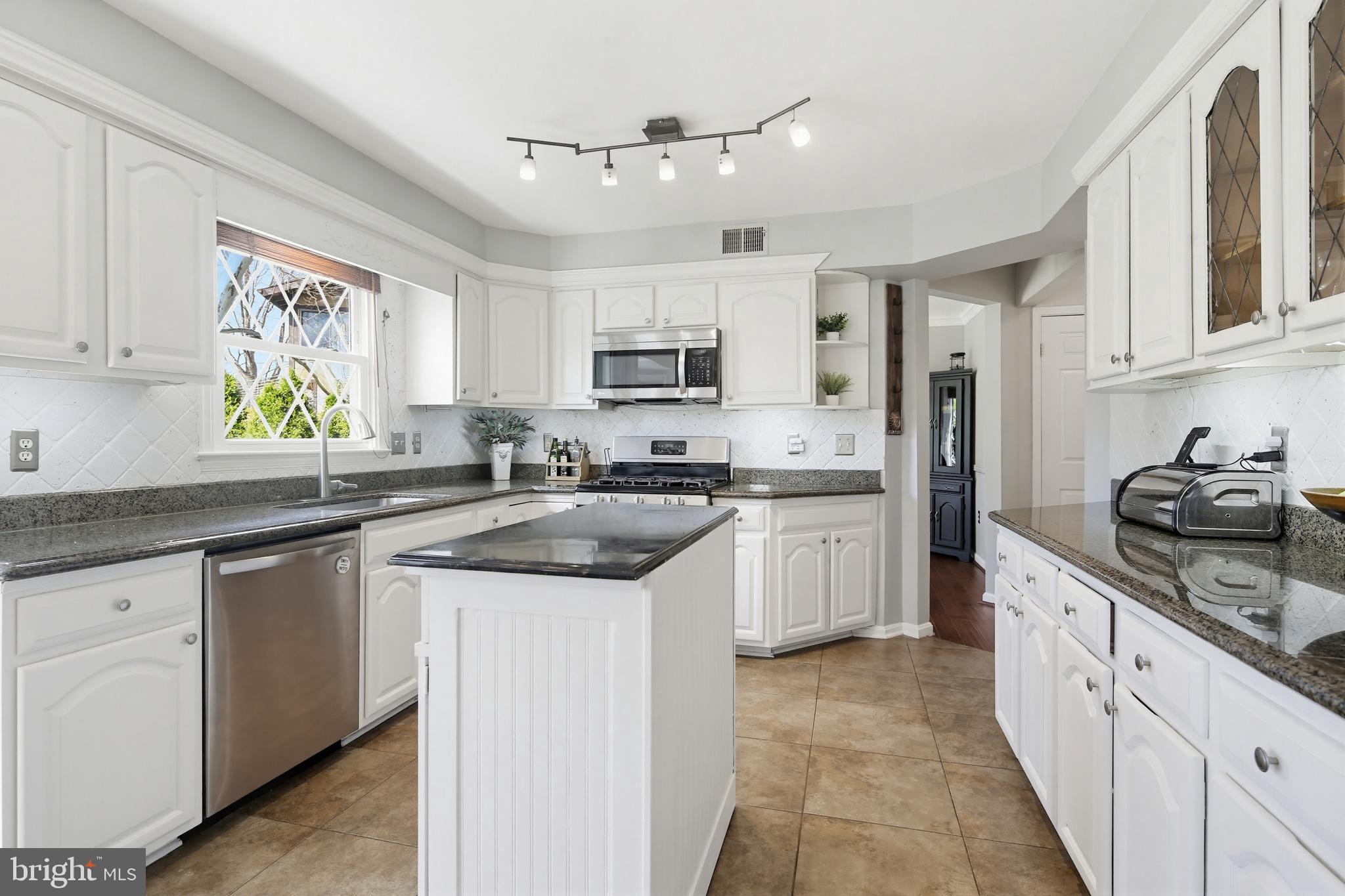 18906 Lindenhouse Road Gaithersburg, MD 20879 - Photo 16 of 48 a kitchen with stainless steel appliances granite countertop a sink stove and refrigerator