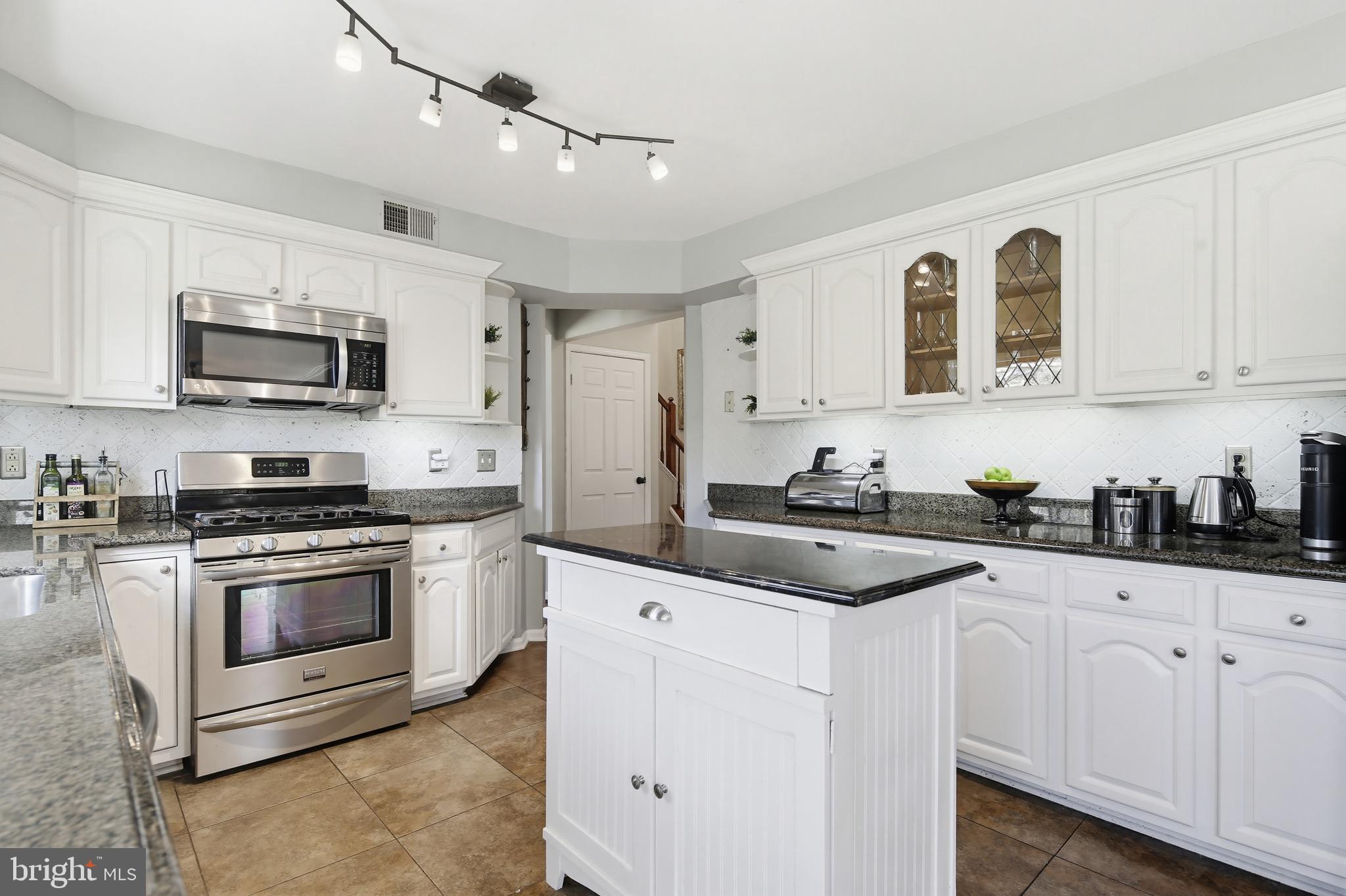 18906 Lindenhouse Road Gaithersburg, MD 20879 - Photo 17 of 48 a kitchen with stainless steel appliances granite countertop a sink and a stove