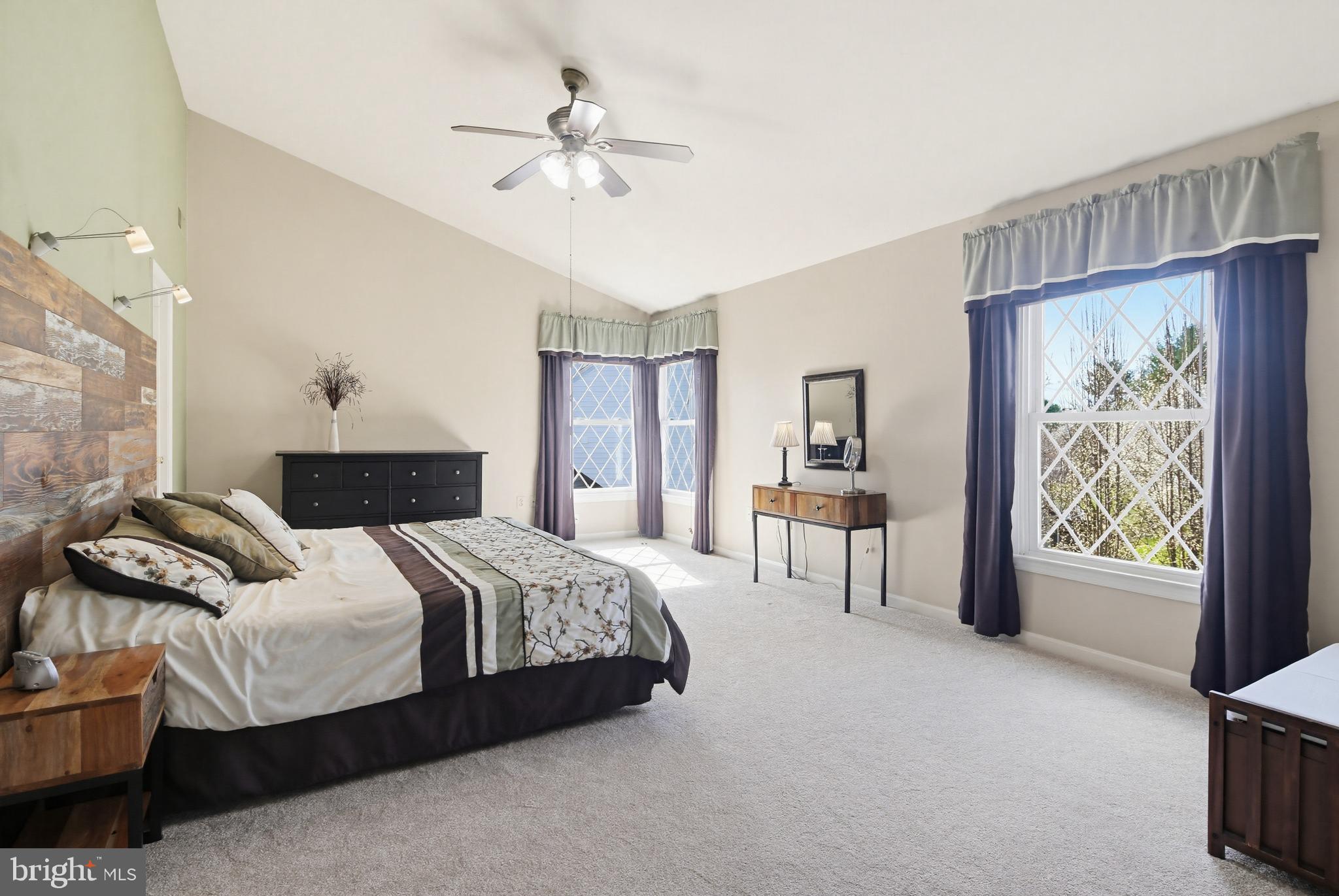 18906 Lindenhouse Road Gaithersburg, MD 20879 - Photo 21 of 48 a bedroom with a large bed and a chandelier