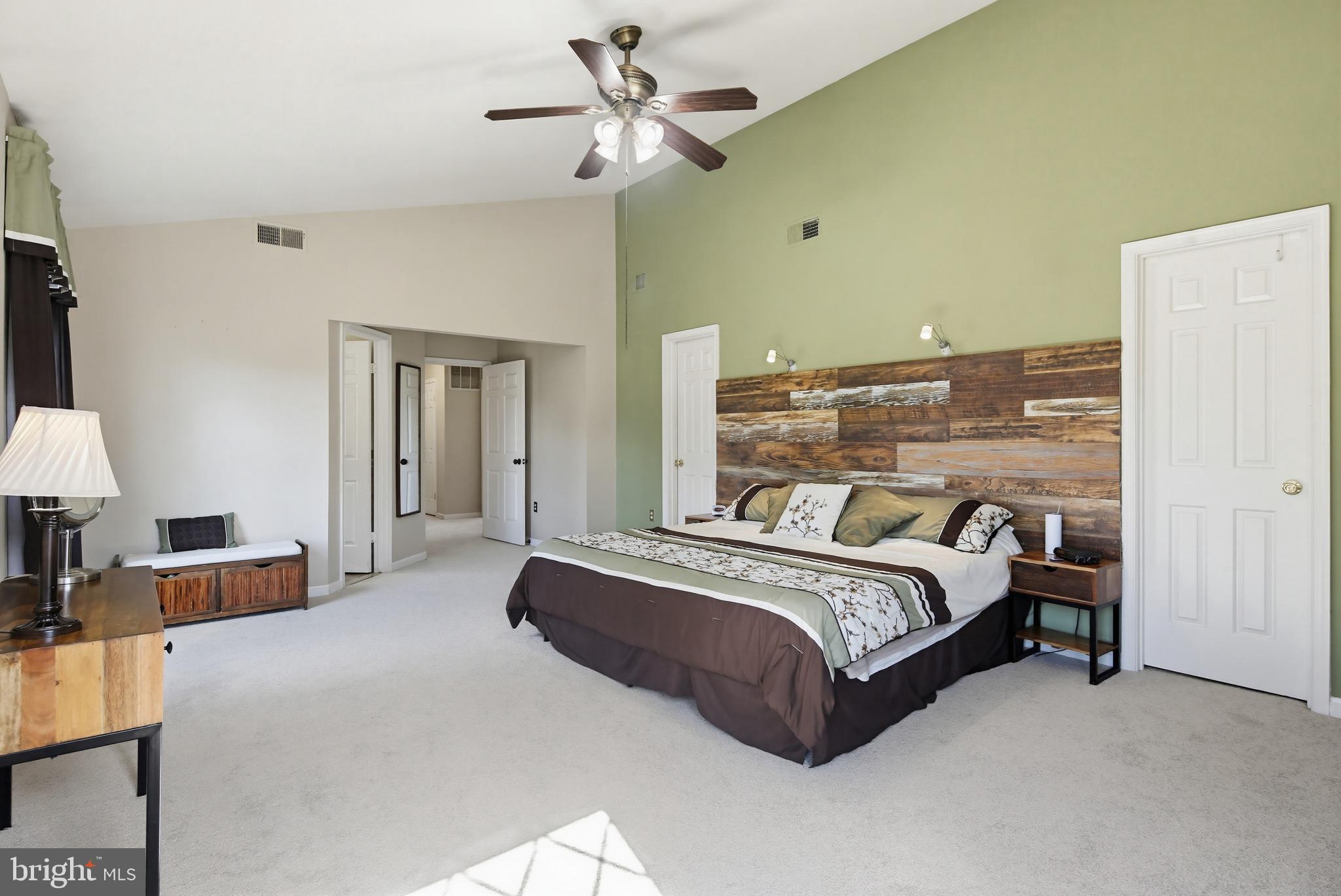 18906 Lindenhouse Road Gaithersburg, MD 20879 - Photo 22 of 48 a bedroom with a bed dresser and a chandelier