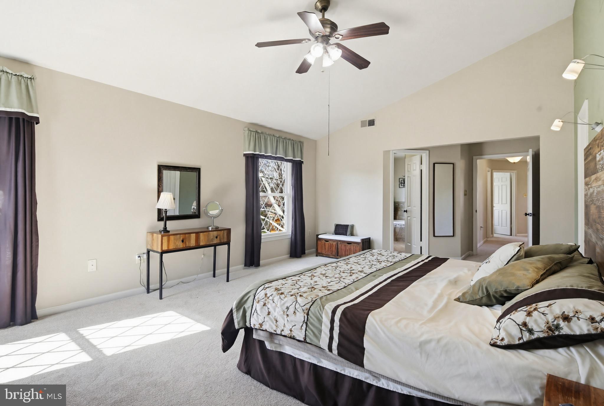 18906 Lindenhouse Road Gaithersburg, MD 20879 - Photo 23 of 48 a bedroom with a bed a chandelier and dresser