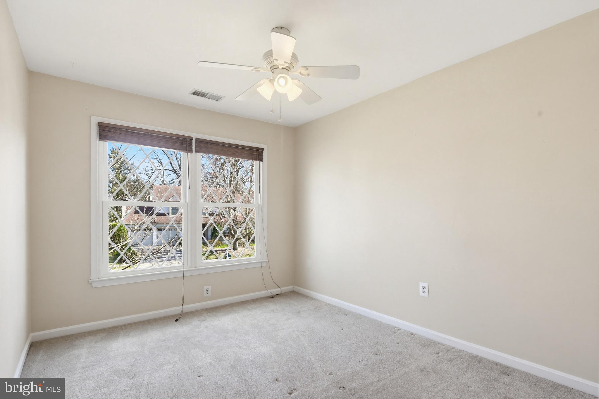 18906 Lindenhouse Road Gaithersburg, MD 20879 - Photo 28 of 48 an empty room with windows and chandelier fan