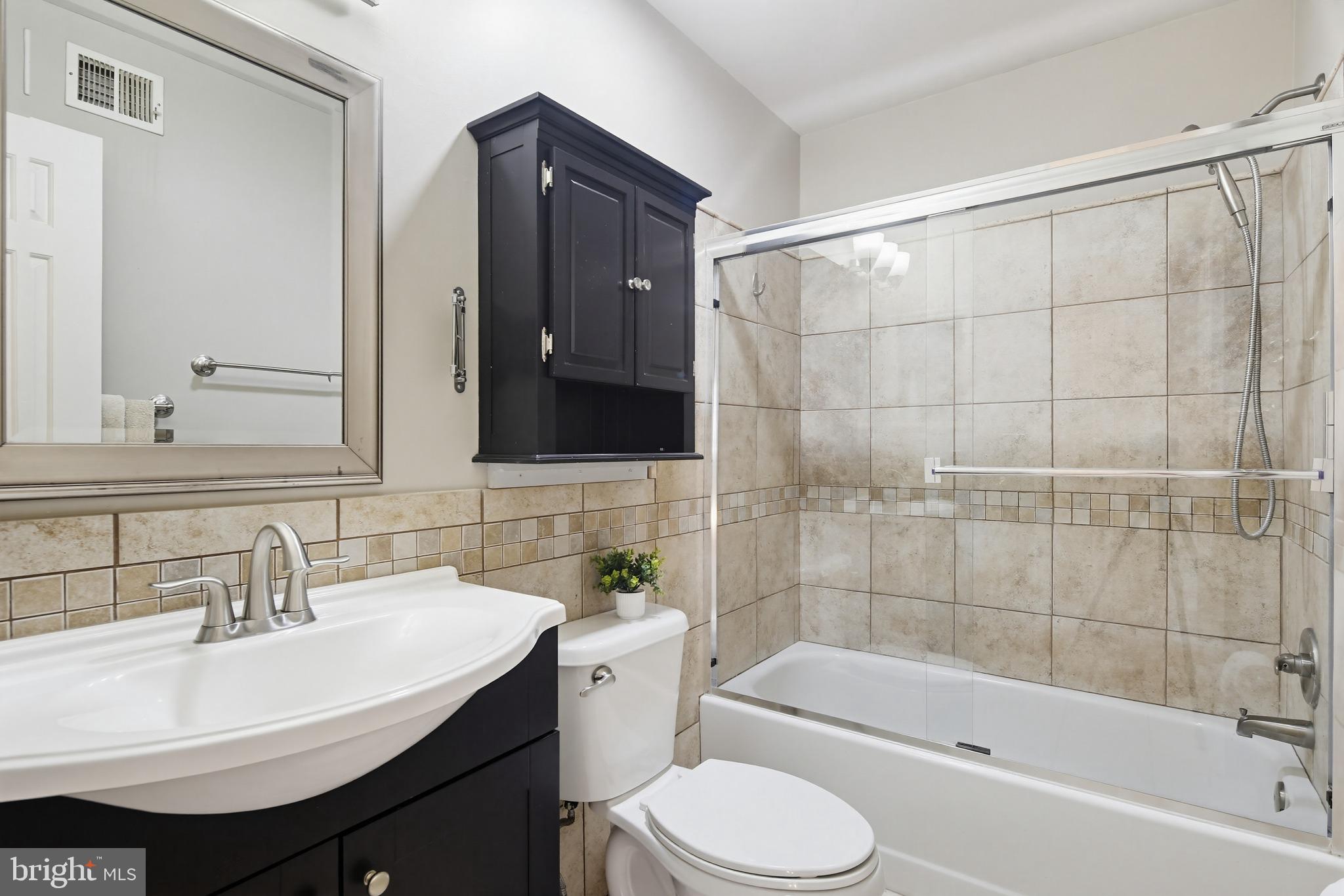 18906 Lindenhouse Road Gaithersburg, MD 20879 - Photo 32 of 48 a bathroom with a sink toilet and shower