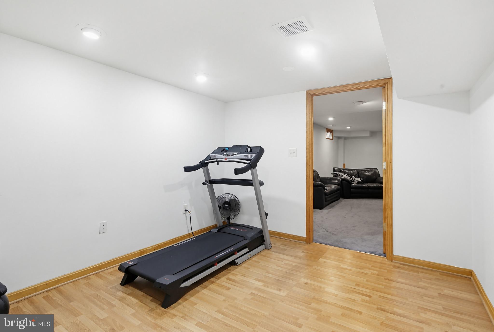 18906 Lindenhouse Road Gaithersburg, MD 20879 - Photo 37 of 48 a room with gym equipment and wooden floor