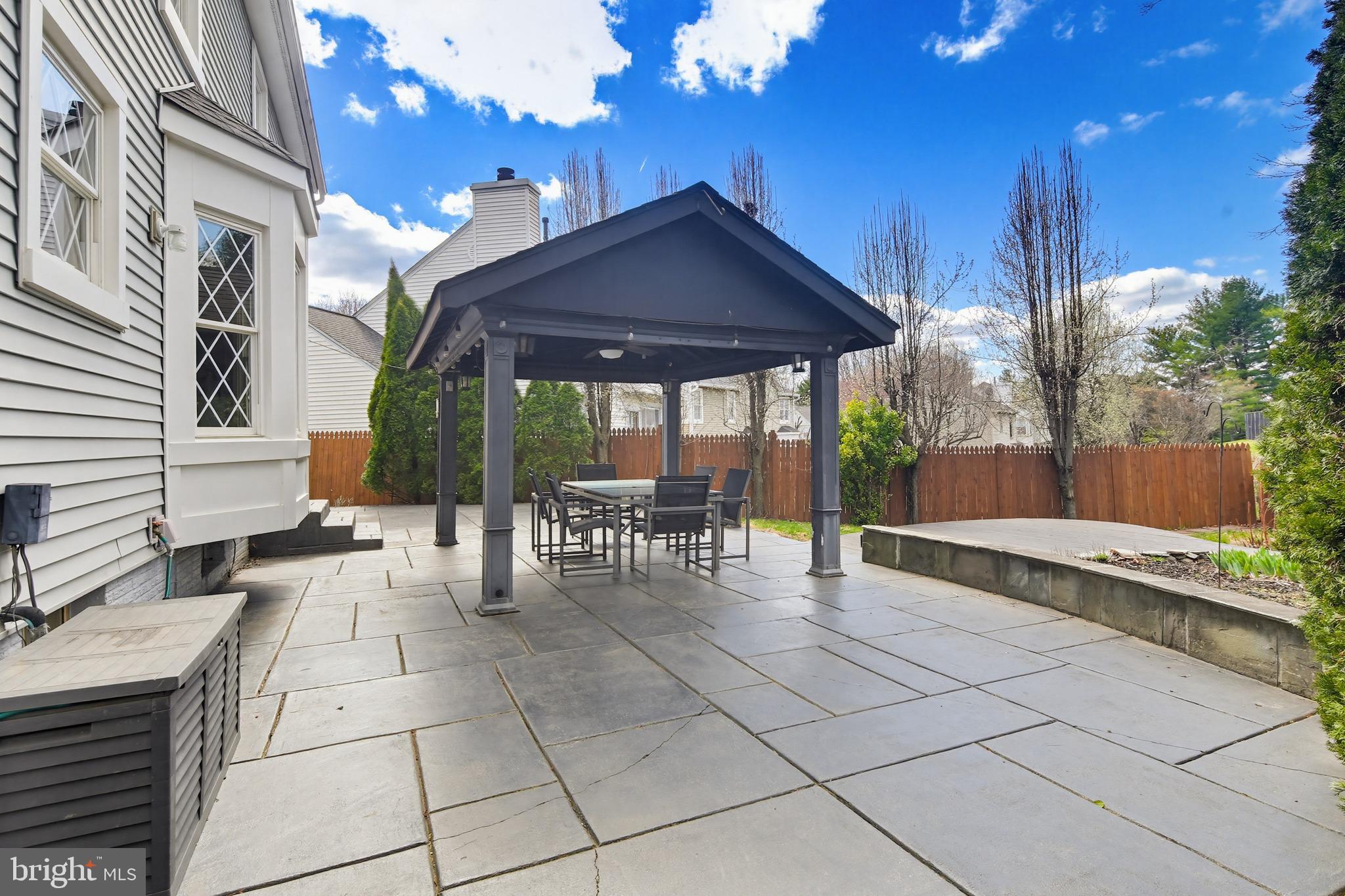 18906 Lindenhouse Road Gaithersburg, MD 20879 - Photo 42 of 48 a view of a patio with table and chairs with wooden floor and plants