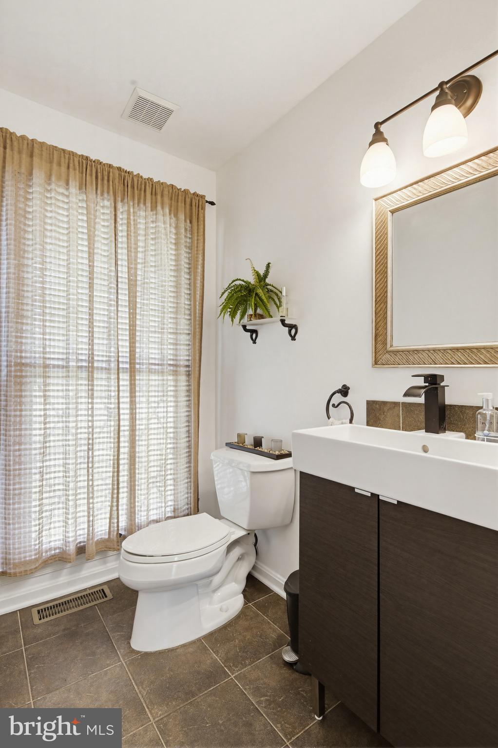 18906 Lindenhouse Road Gaithersburg, MD 20879 - Photo 10 of 48 a bathroom with a sink a toilet and a mirror