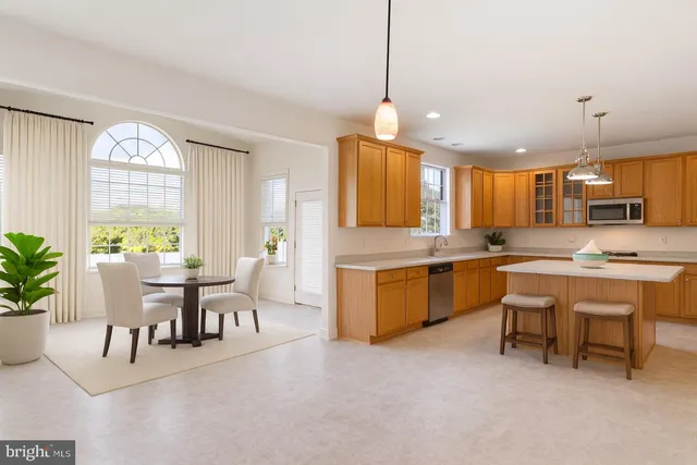 a large kitchen with a table and chairs