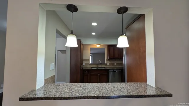 a kitchen with a refrigerator a stove and a microwave