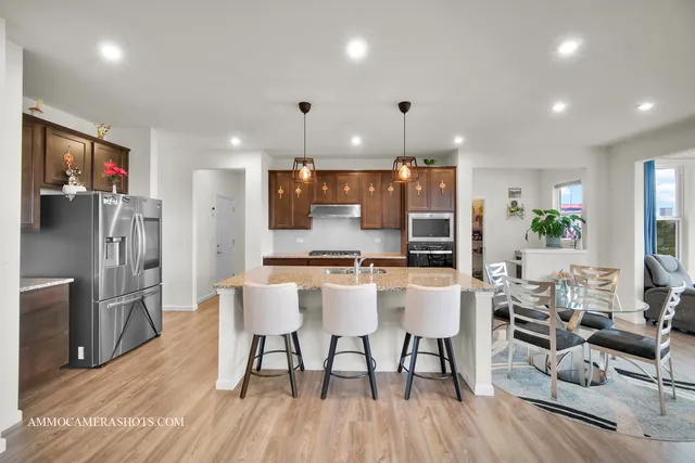 a large kitchen with a table and chairs in it
