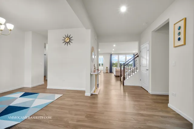 a hallway with wooden floor and a chandelier