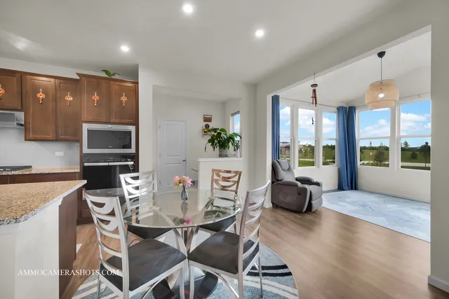 a dining room with furniture and wooden floor