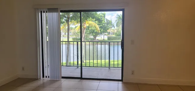 a bathroom with a granite countertop toilet sink and mirror