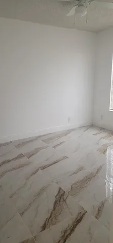 a kitchen with granite countertop a stove top oven cabinetry a sink and a microwave