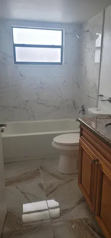 a view of a lake with a house and large trees