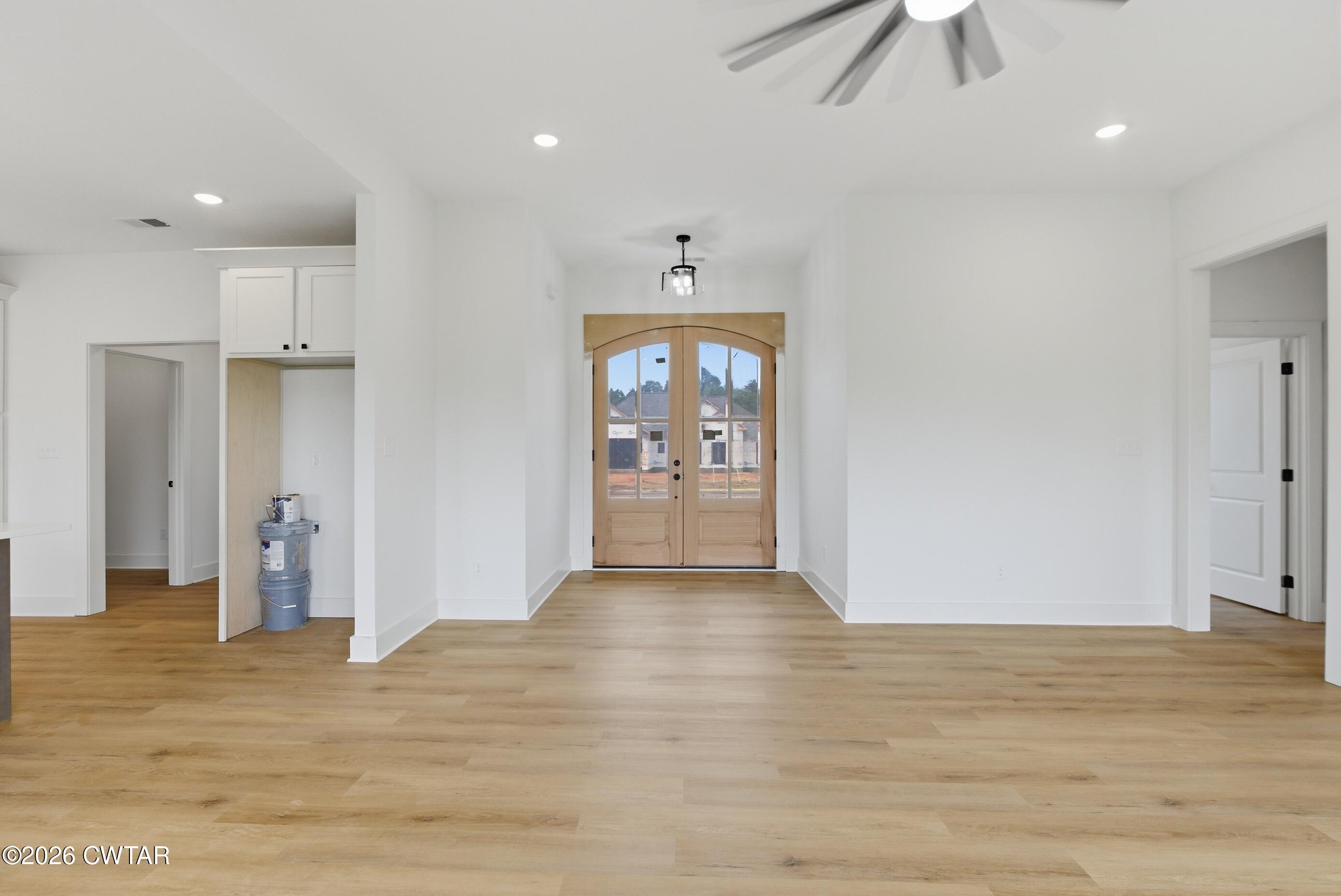 179 Daybreak Loop Medina, TN 38355 - Photo 13 of 32 an empty room with wooden floor and windows