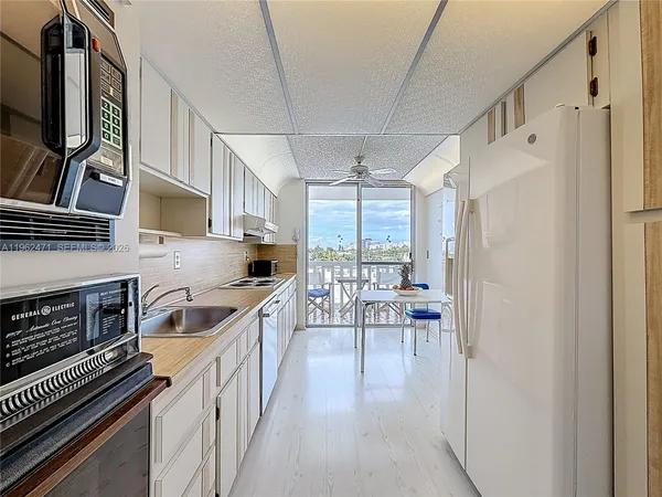 a kitchen with granite countertop a stove and a refrigerator