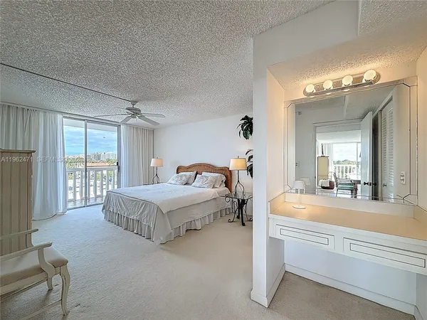 a bedroom with a bed and a large mirror
