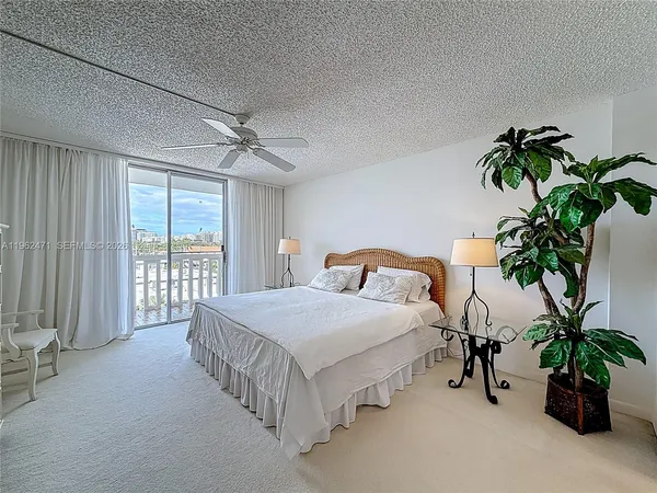 a bedroom with a bed and a potted plant
