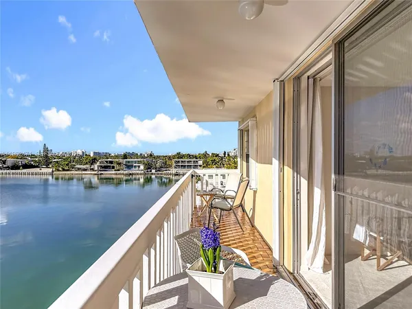 a view of a balcony with lake view and wooden floor