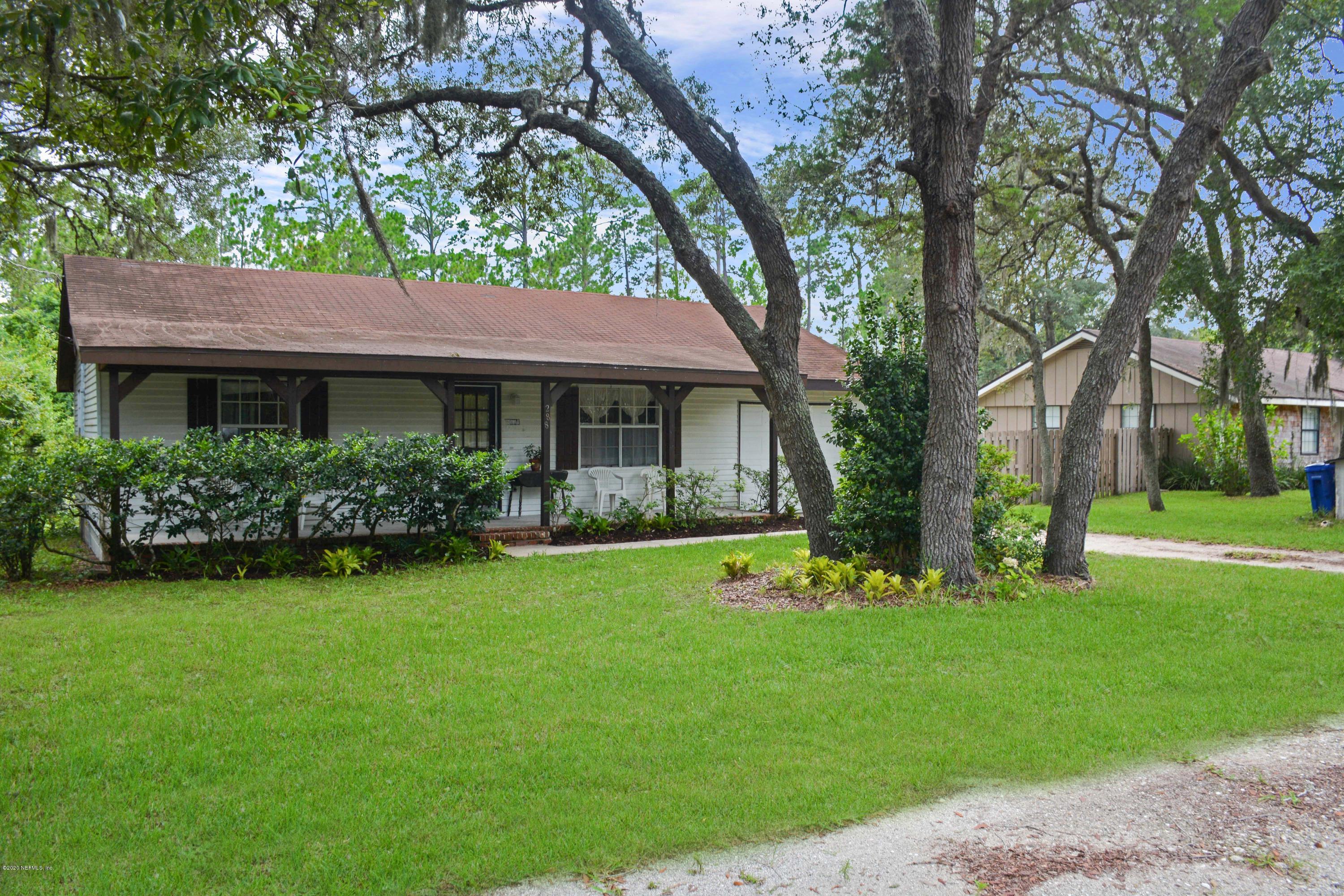 288 Cornell Road St. Augustine, FL 32086 - Photo 1 of 26 a front view of a house with a garden