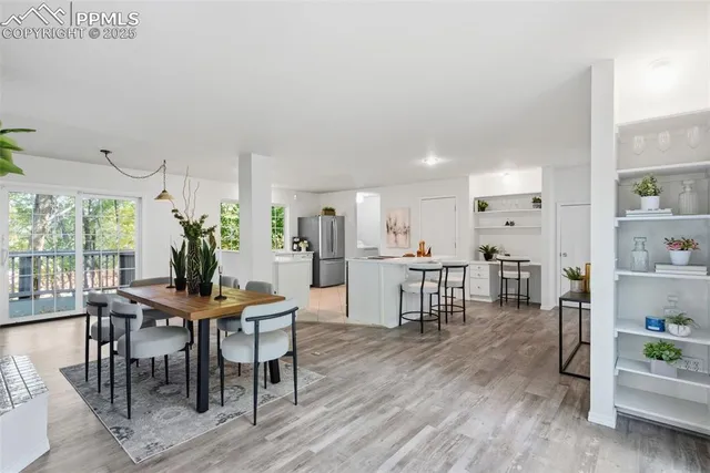 a view of a dining room with furniture and wooden floor