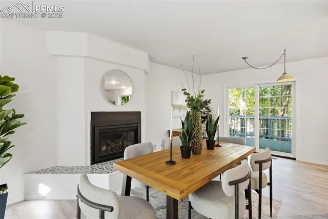 a dining room with furniture and wooden floor