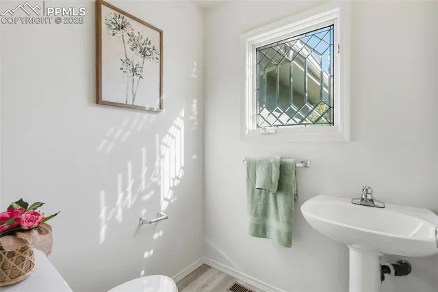 a bathroom with a toilet sink and mirror