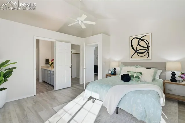 a bedroom with a large bed and a chandelier