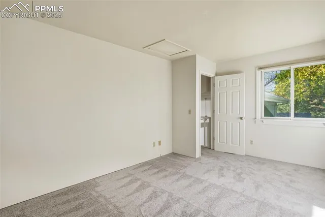 an empty room with large windows