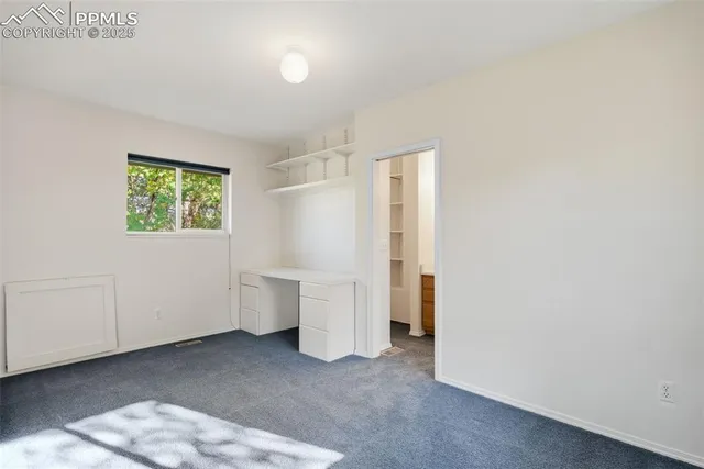 a view of a room with closet and white walls