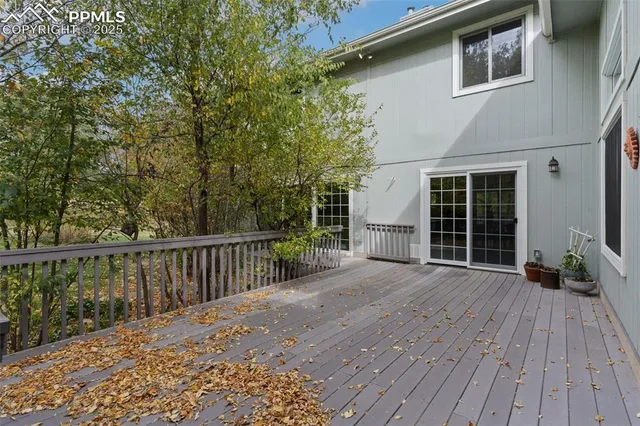 a view of backyard with deck and wooden floor