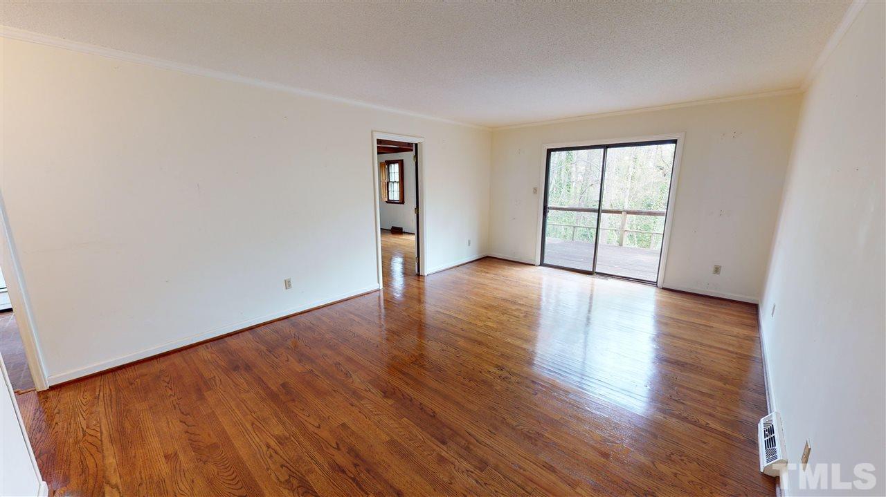 1114 Manchester Drive Raleigh, NC 27609 - Photo 11 of 30 an empty room with wooden floor and windows