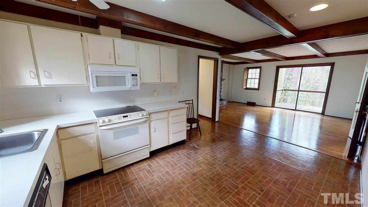 1114 Manchester Drive Raleigh, NC 27609 - Photo 13 of 30 a kitchen with stainless steel appliances granite countertop a stove a sink and a refrigerator
