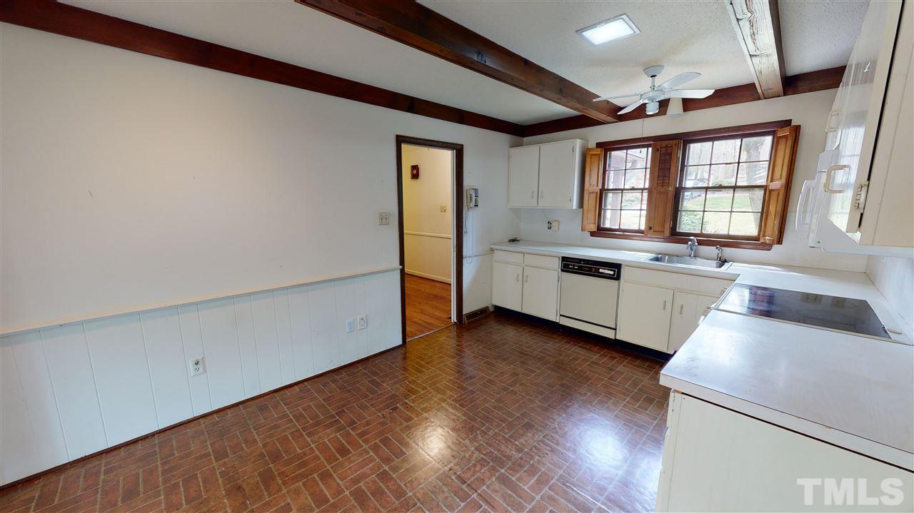 1114 Manchester Drive Raleigh, NC 27609 - Photo 14 of 30 a view of a kitchen with a fridge and wooden floor