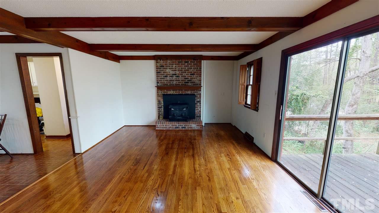 1114 Manchester Drive Raleigh, NC 27609 - Photo 16 of 30 a view of an empty room with wooden floor and a window