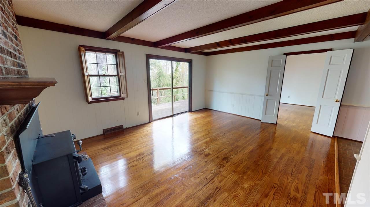 1114 Manchester Drive Raleigh, NC 27609 - Photo 17 of 30 a view of an empty room with wooden floor and a window