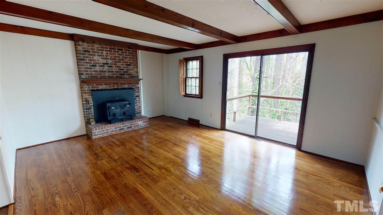 1114 Manchester Drive Raleigh, NC 27609 - Photo 18 of 30 a view of an empty room with wooden floor and a window